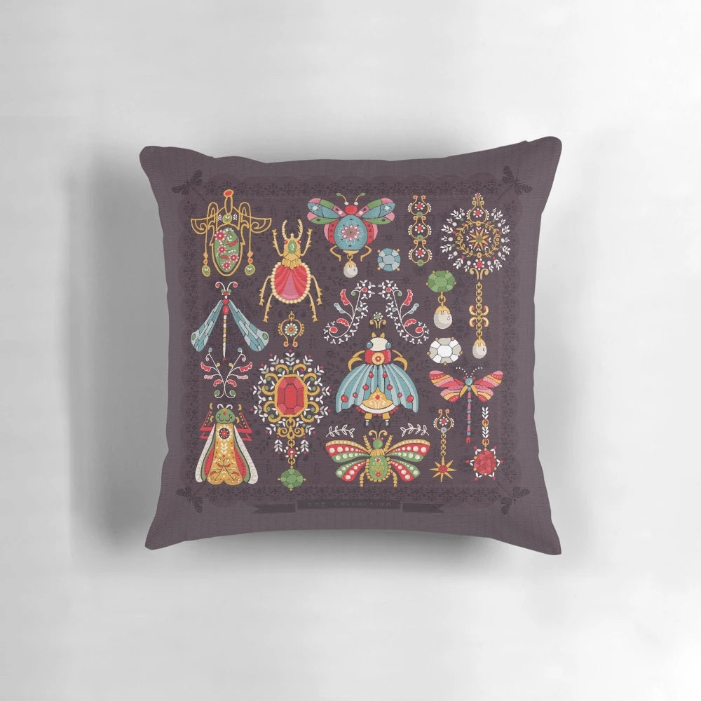 Vibrant, Victorian-styled pillow featuring intricate bug and jewelry designs