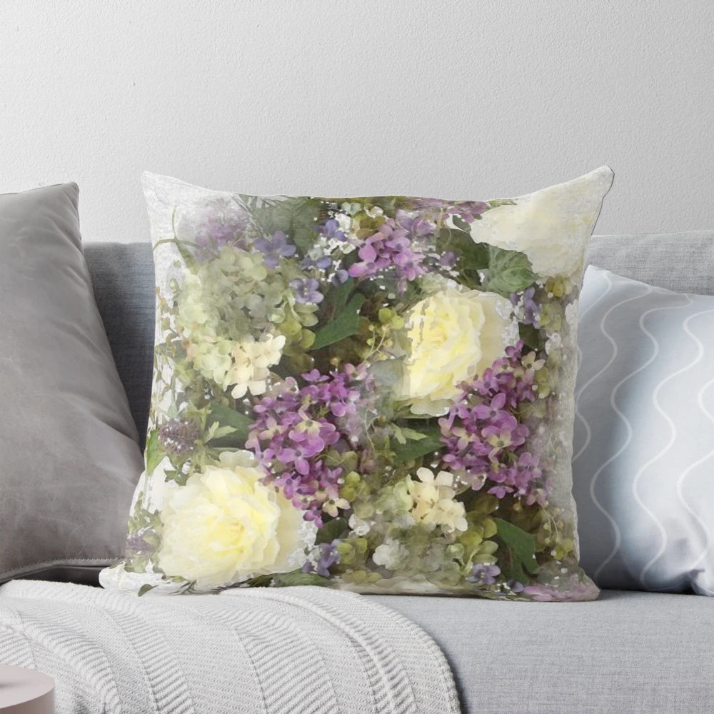A watercolor painting of a bouquet featuring cream roses and purple flowers on a throw pillow