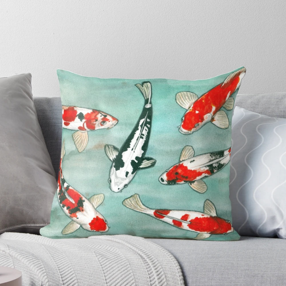 A decorative throw pillow featuring a beautiful watercolor painting of koi fish swimming in a pond.