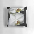 Close-up image of a beautiful white orchid flower on a decorative pillow