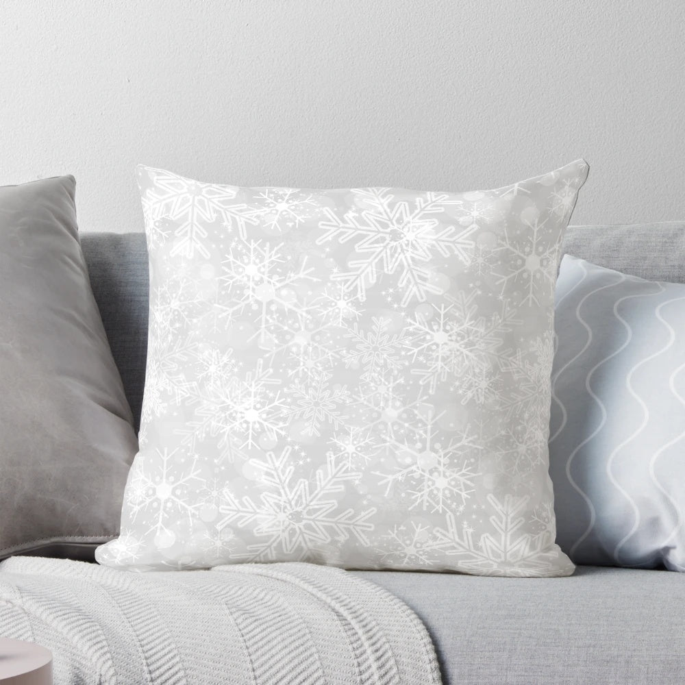 A modern, silver snowflake pattern decorative pillow for winter and holiday home decor.