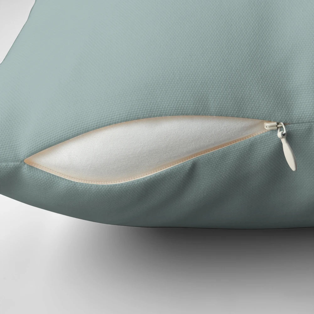 A blue pillow featuring the four elements of Avatar: The Last Airbender - earth, fire, air, and water.