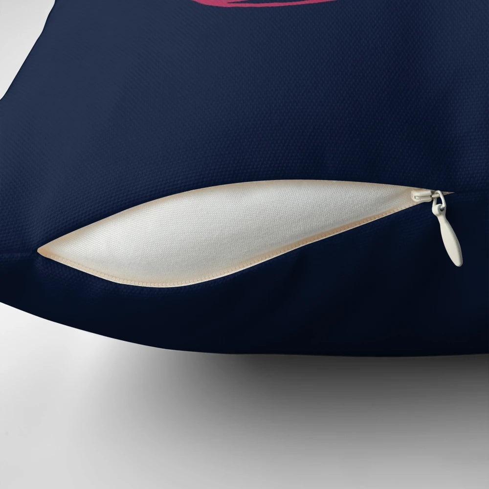 Close-up view of a dark blue and white abstract pillow with swirling elemental design