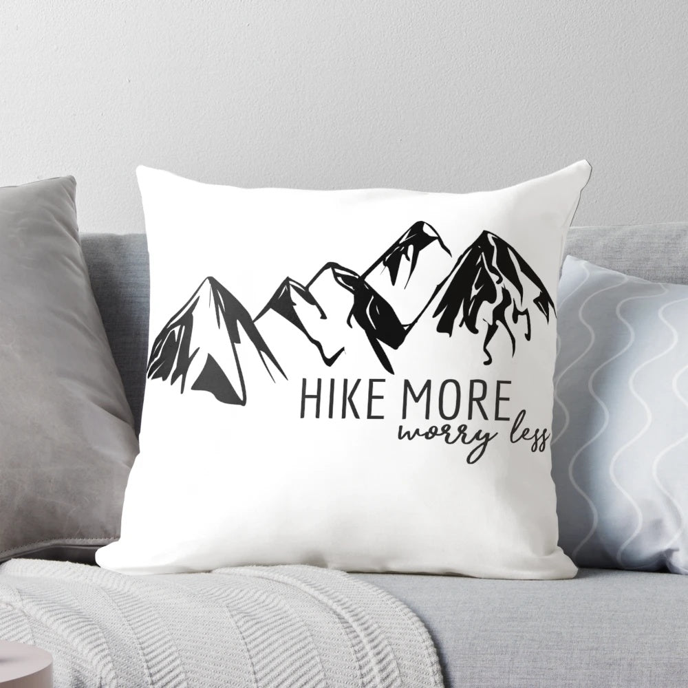 A cozy hiking pillow featuring a mountain graphic, perfect for outdoor adventures.
