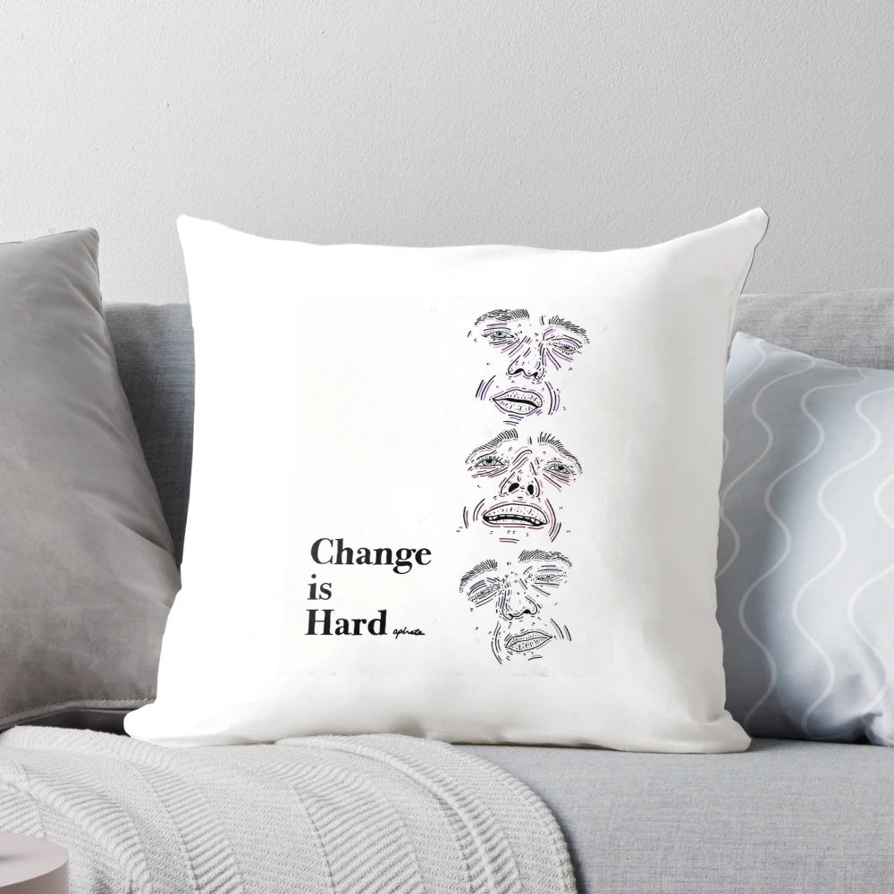 A simple white pillow with the text "Change Is Hard" in a minimalist outline design, inspiring personal reflection and growth.