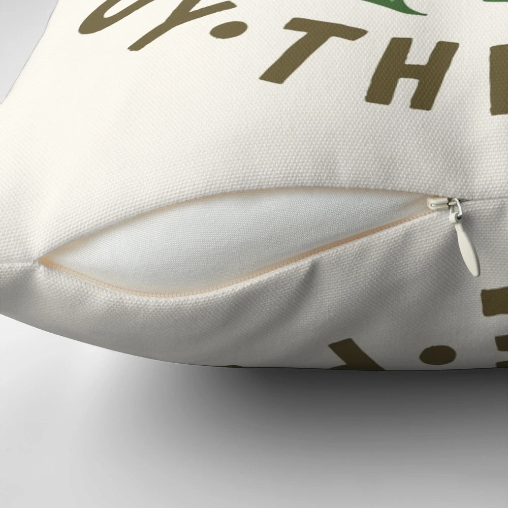 A decorative throw pillow featuring the whimsical message "Life is Short, Buy the Plant" against a lush, tropical plant background.