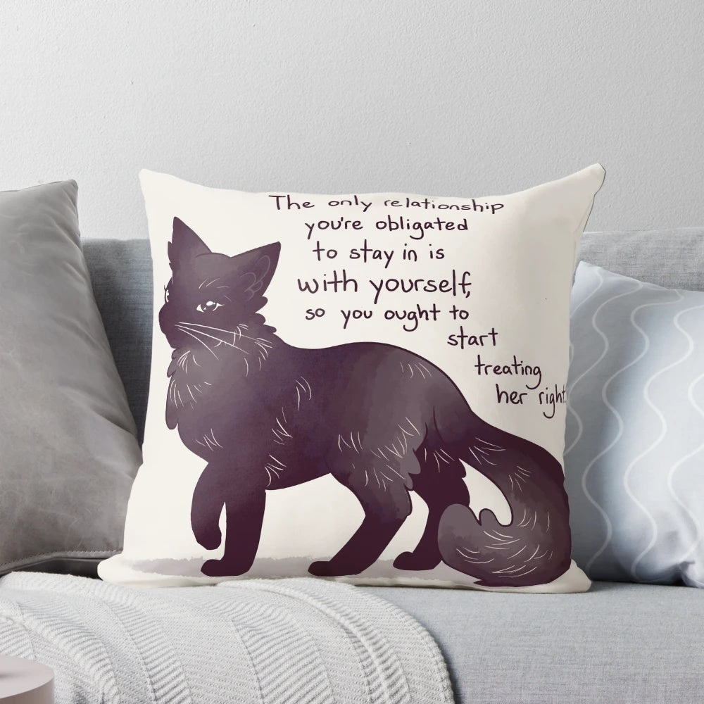 A black cat pillow with an inspiring message about self-love and mental health recovery