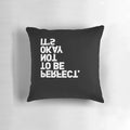 Black-and-white pillow with the text "YES, IT IS" printed upside-down, a playful and ironic home decor item.