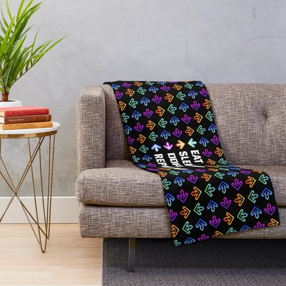 Soft white plush blanket with text "Eat. Sleep. DDR. Repeat.