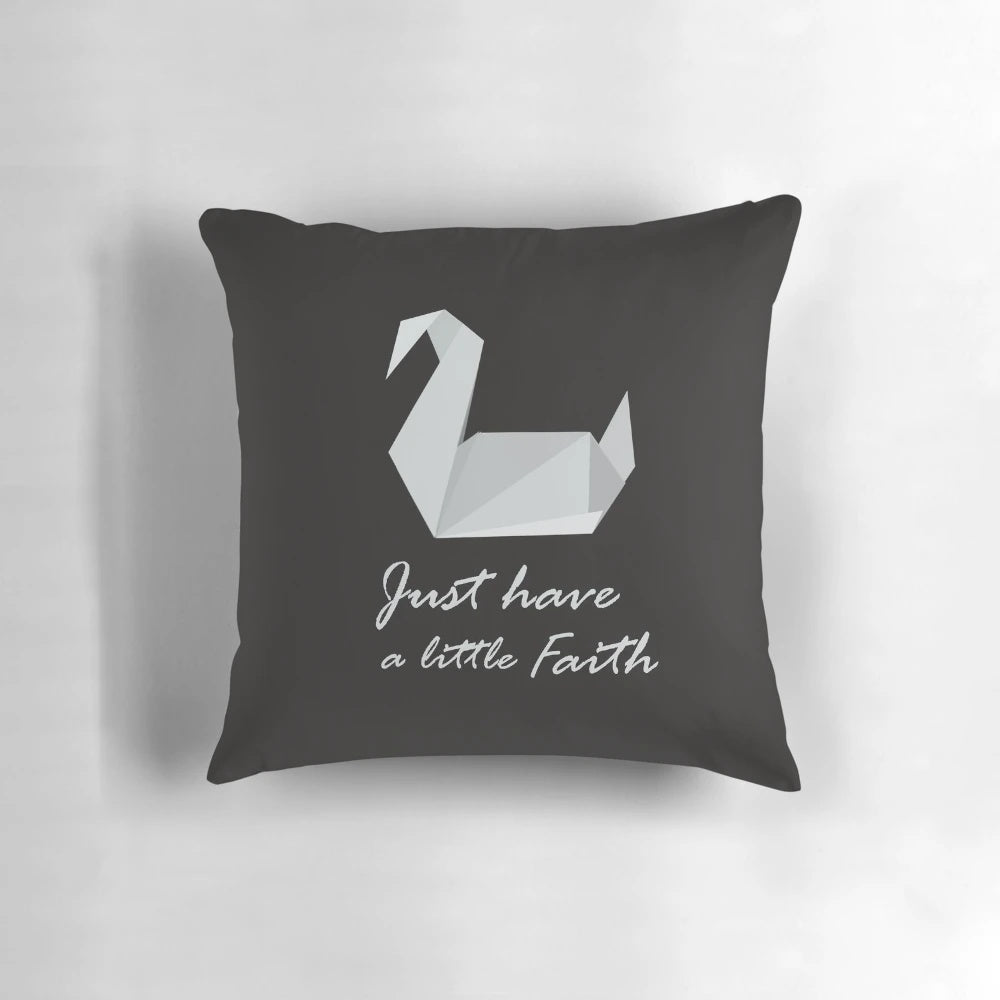 A cozy prison break-inspired pillow featuring an origami swan and the quote "Just Have a Little Faith"