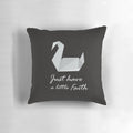 A cozy prison break-inspired pillow featuring an origami swan and the quote "Just Have a Little Faith"