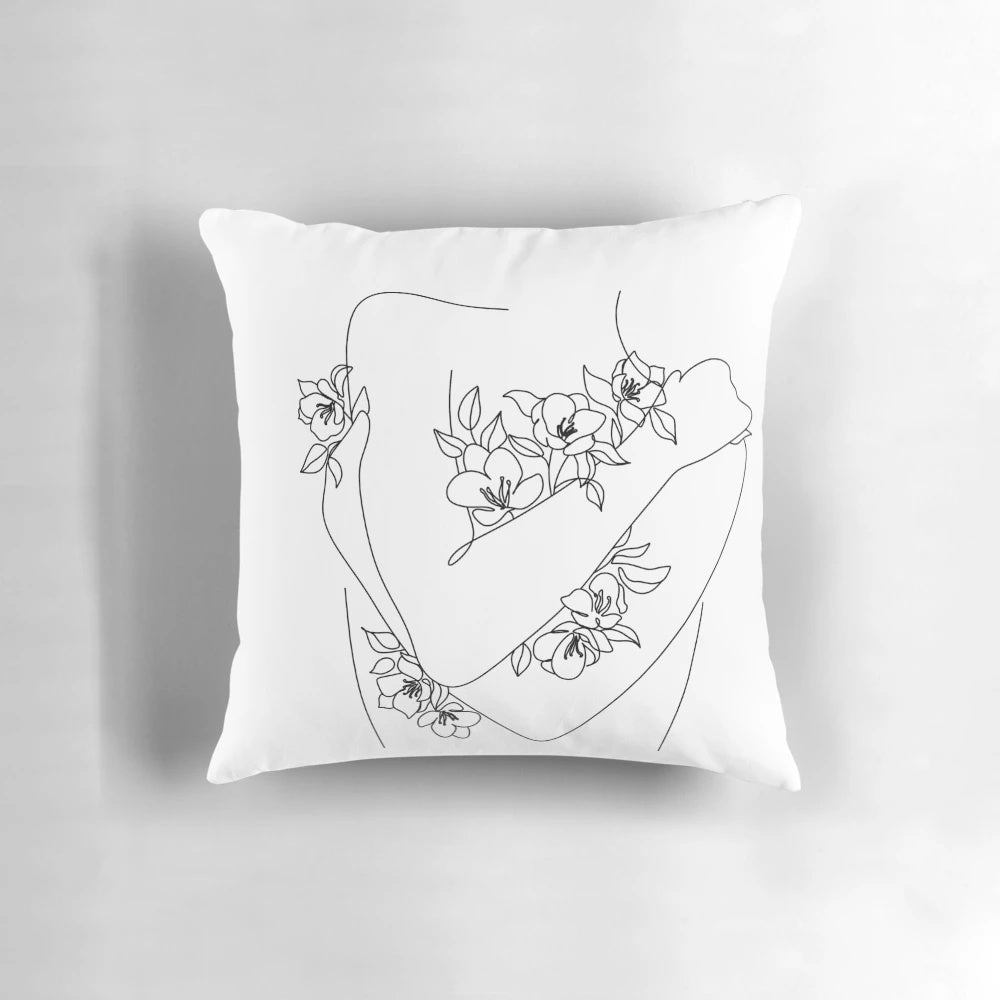 A line art illustration of a woman embracing herself, with flowers growing around her.