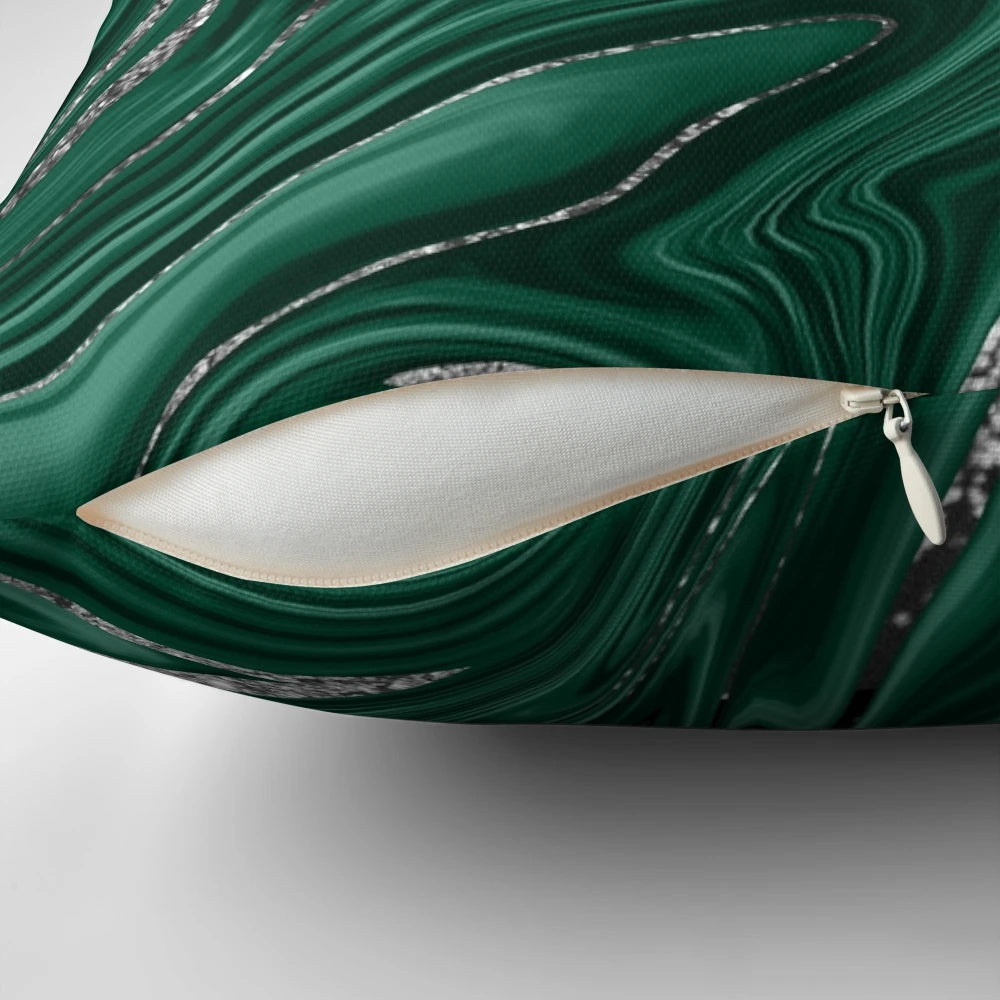 Emerald green and black silver marble patterned pillow with a liquified, wavy texture