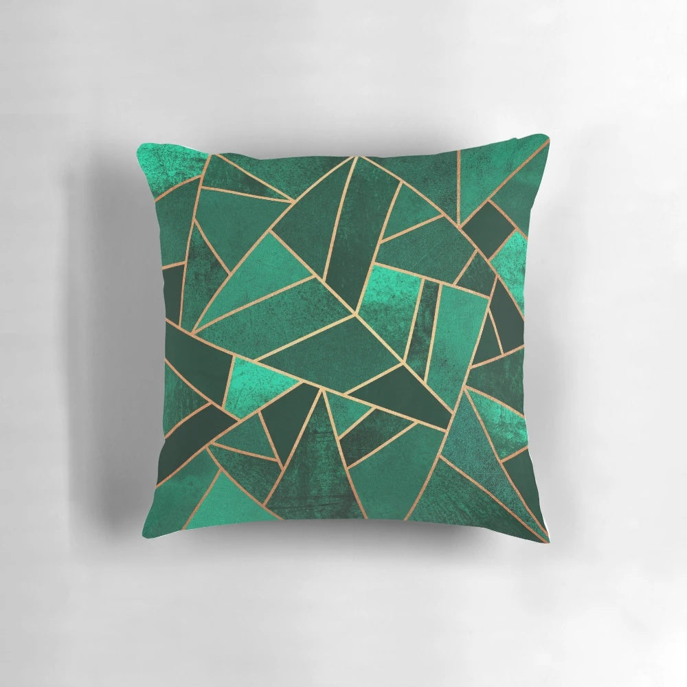Close-up of an emerald green and copper modern geometric pattern throw pillow