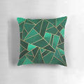 Close-up of an emerald green and copper modern geometric pattern throw pillow