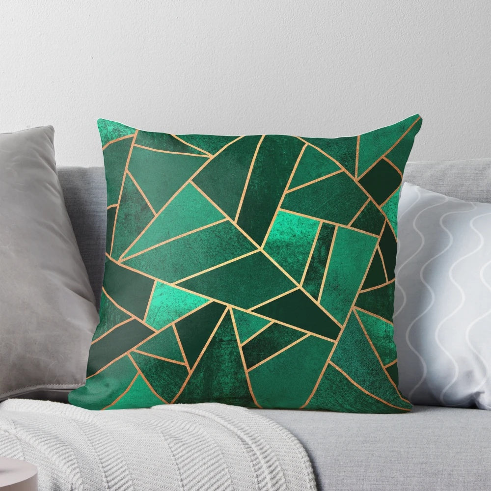 Close-up of an emerald green and copper modern geometric pattern throw pillow