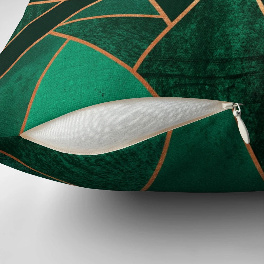 Close-up of an emerald green and copper modern geometric pattern throw pillow