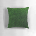 Emerald green velvet accent pillow with a soft, textured surface for modern, minimalist home decor.