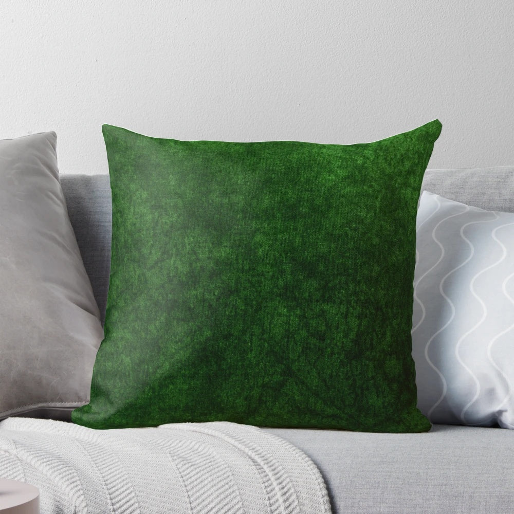Emerald green velvet accent pillow with a soft, textured surface for modern, minimalist home decor.