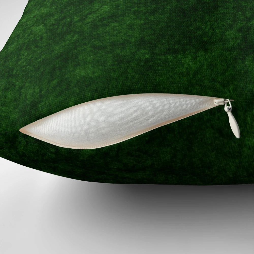 Emerald green velvet accent pillow with a soft, textured surface for modern, minimalist home decor.