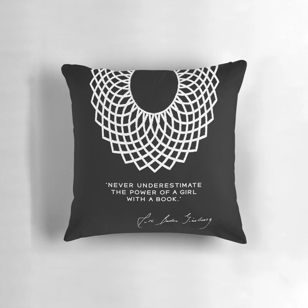 Pillow featuring the text "RBG Never Underestimate the Power of a Girl With a Book" with images of books and a female figure.
