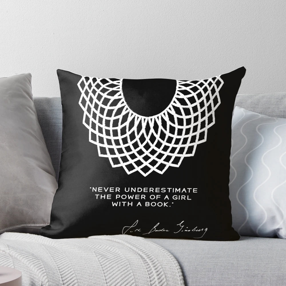 Pillow featuring the text "RBG Never Underestimate the Power of a Girl With a Book" with images of books and a female figure.