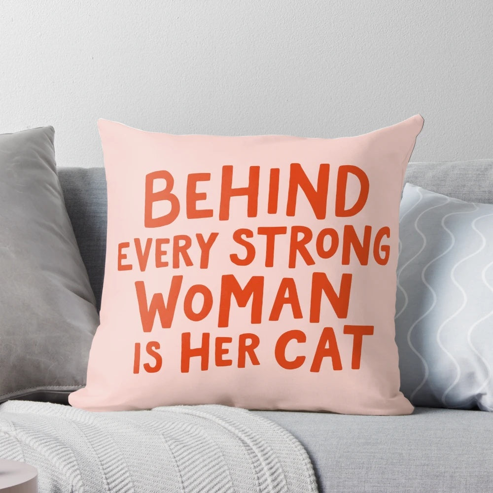 Pillow with text "Behind Every Strong Woman" and cats