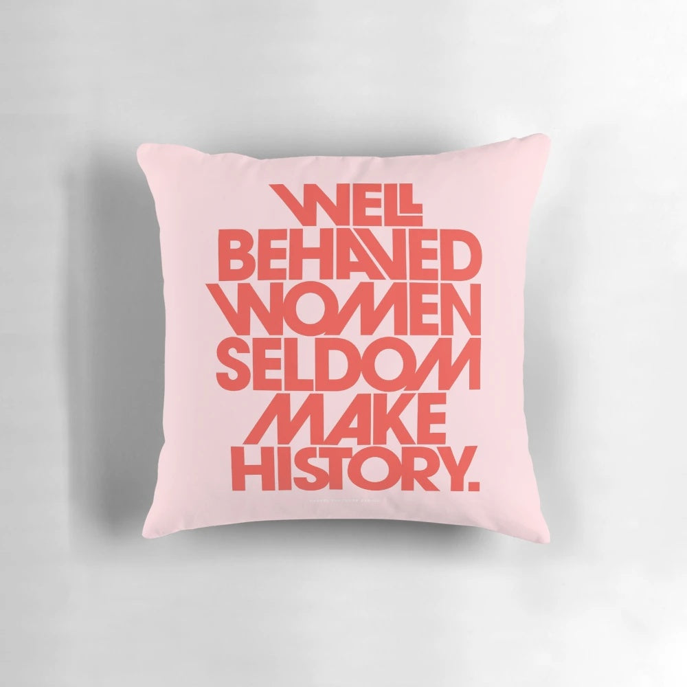 Decorative pink and red throw pillow with the quote "Well Behaved Women Seldom Make History"