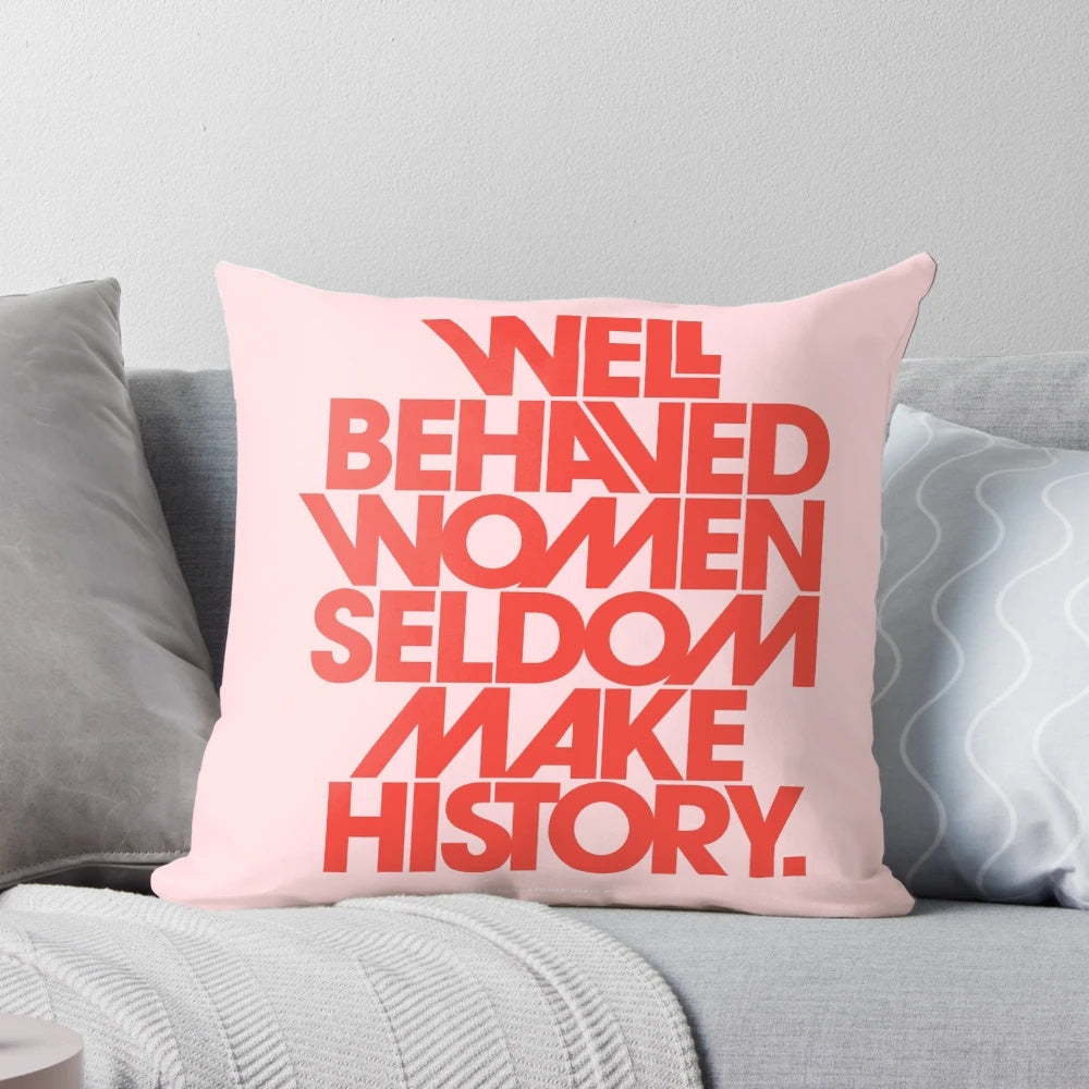 Decorative pink and red throw pillow with the quote "Well Behaved Women Seldom Make History"