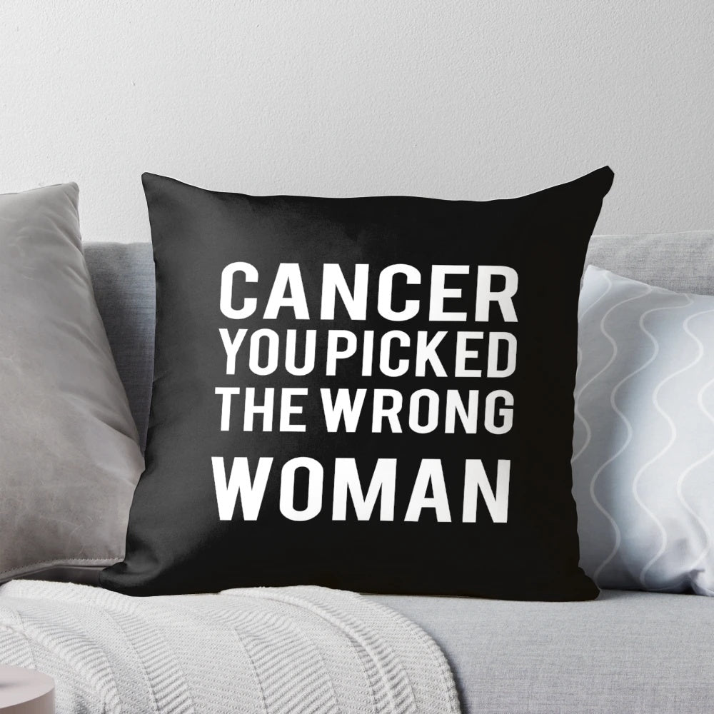 A white pillow with the text "Cancer: You Picked the Wrong Woman" printed on it, representing the strength and resilience of a cancer survivor.