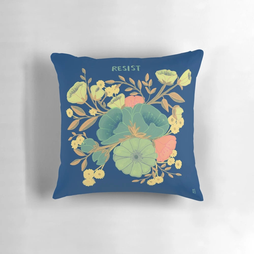 A beautiful blue and white pillow with a floral design and the words "nevertheless she persisted" - an inspirational home decor item for female empowerment.