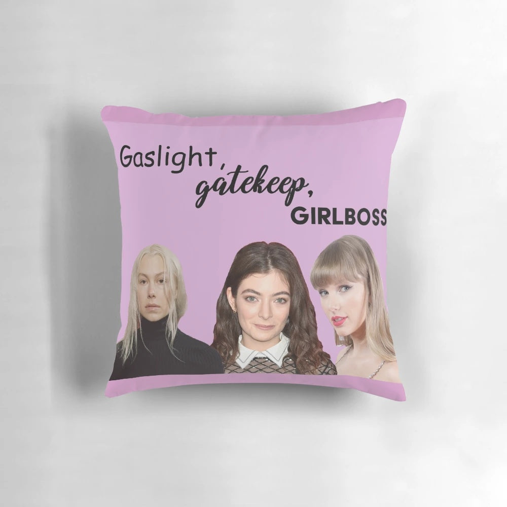 A decorative throw pillow with the text "Gaslight Gatekeep Girl Boss" in a bold, stylish font.