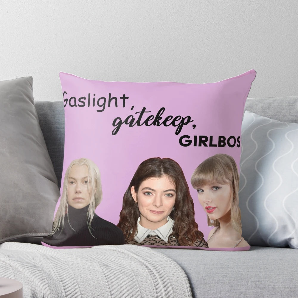 A decorative throw pillow with the text "Gaslight Gatekeep Girl Boss" in a bold, stylish font.