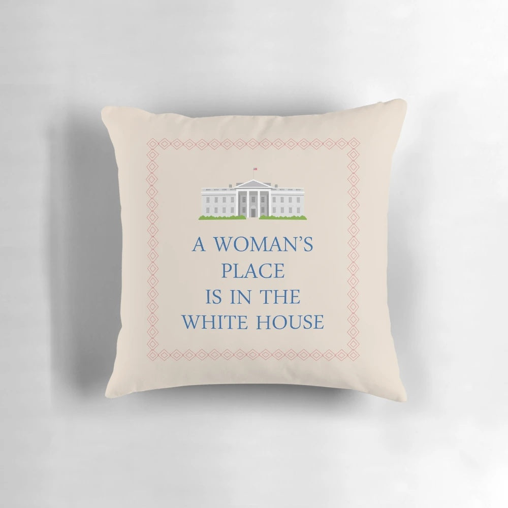 A decorative pillow with the text "A Woman's Place is in the White House"