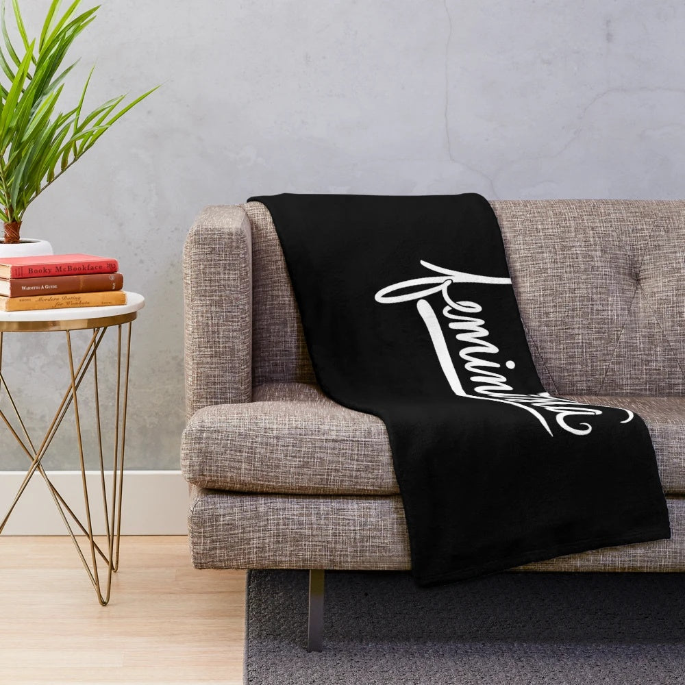 Soft, cozy plush blanket featuring a feminist design