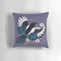 Whimsical throw pillow featuring a vibrant illustration of a European magpie bird surrounded by purple flowers and stars