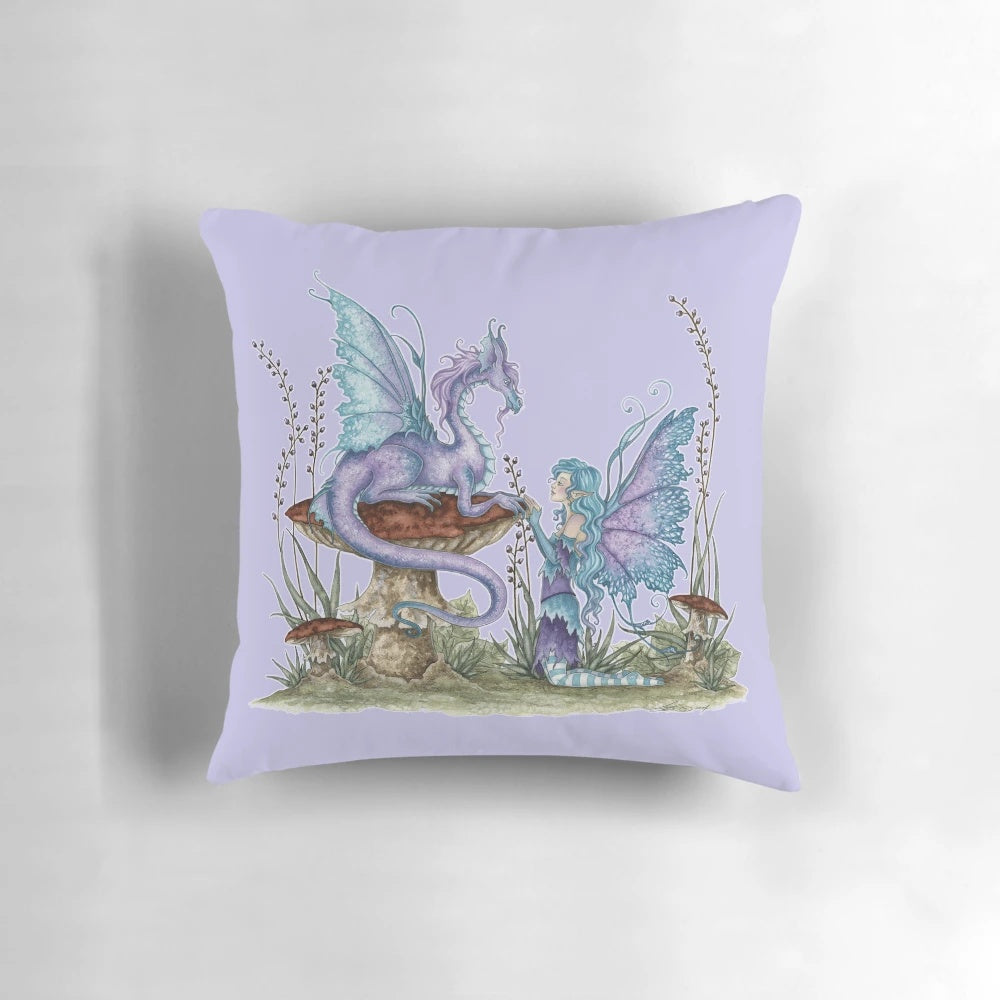 A soft, plush pillow featuring a fantasy fairy design with a dragon, mushrooms, and vibrant purple and blue colors.