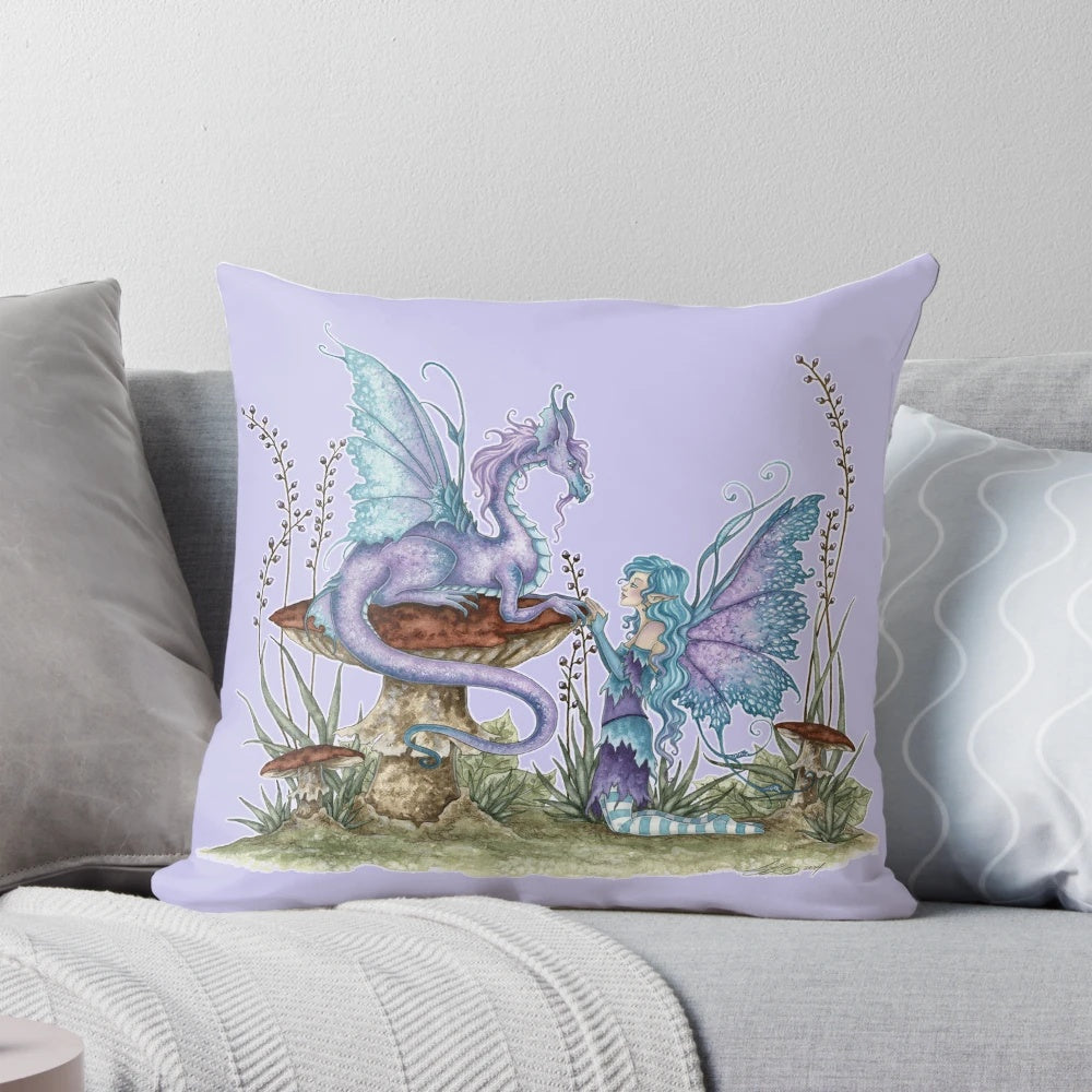 A soft, plush pillow featuring a fantasy fairy design with a dragon, mushrooms, and vibrant purple and blue colors.