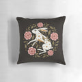 A captivating pillow featuring an intricate, nature-inspired design with rabbits, flowers, and stars.