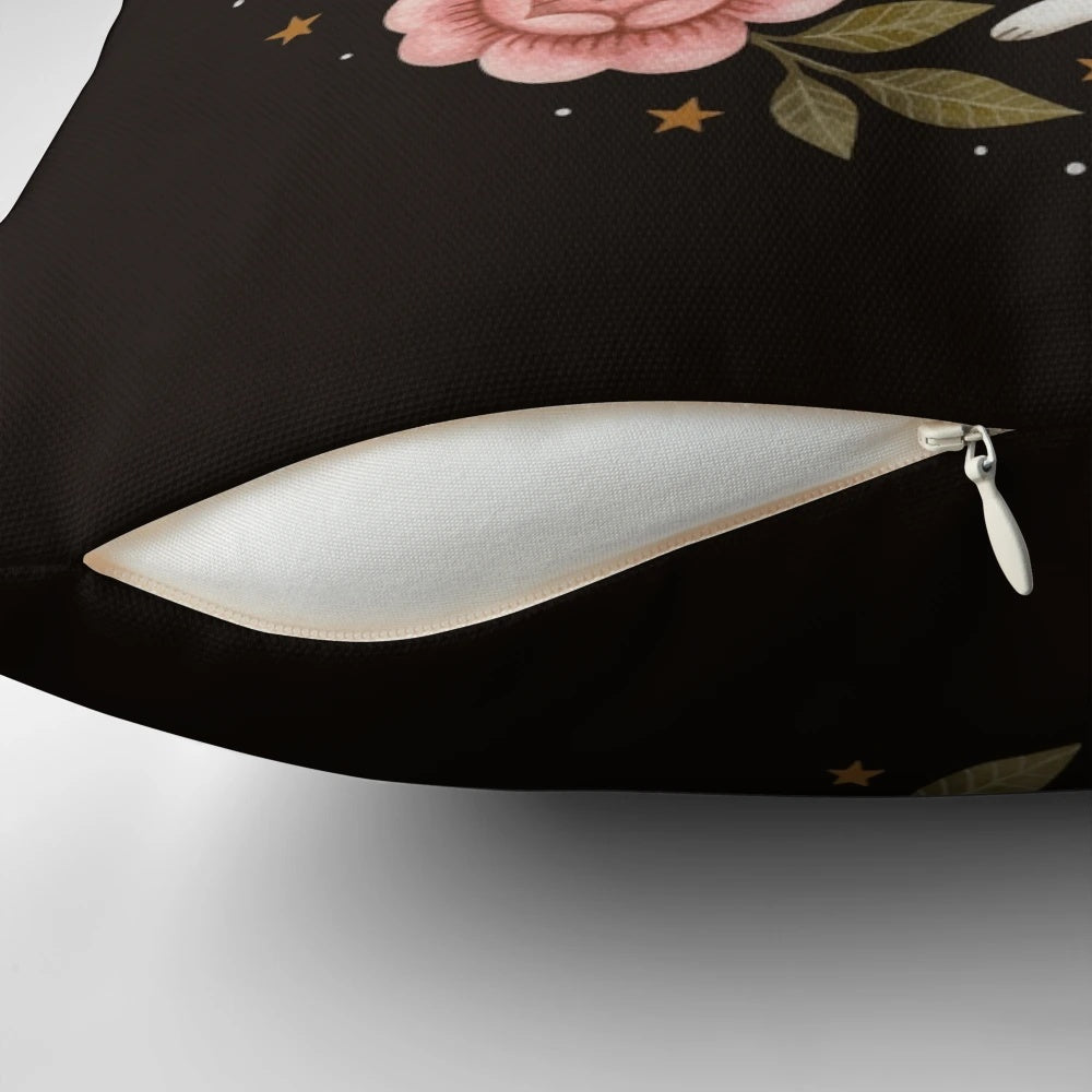A captivating pillow featuring an intricate, nature-inspired design with rabbits, flowers, and stars.