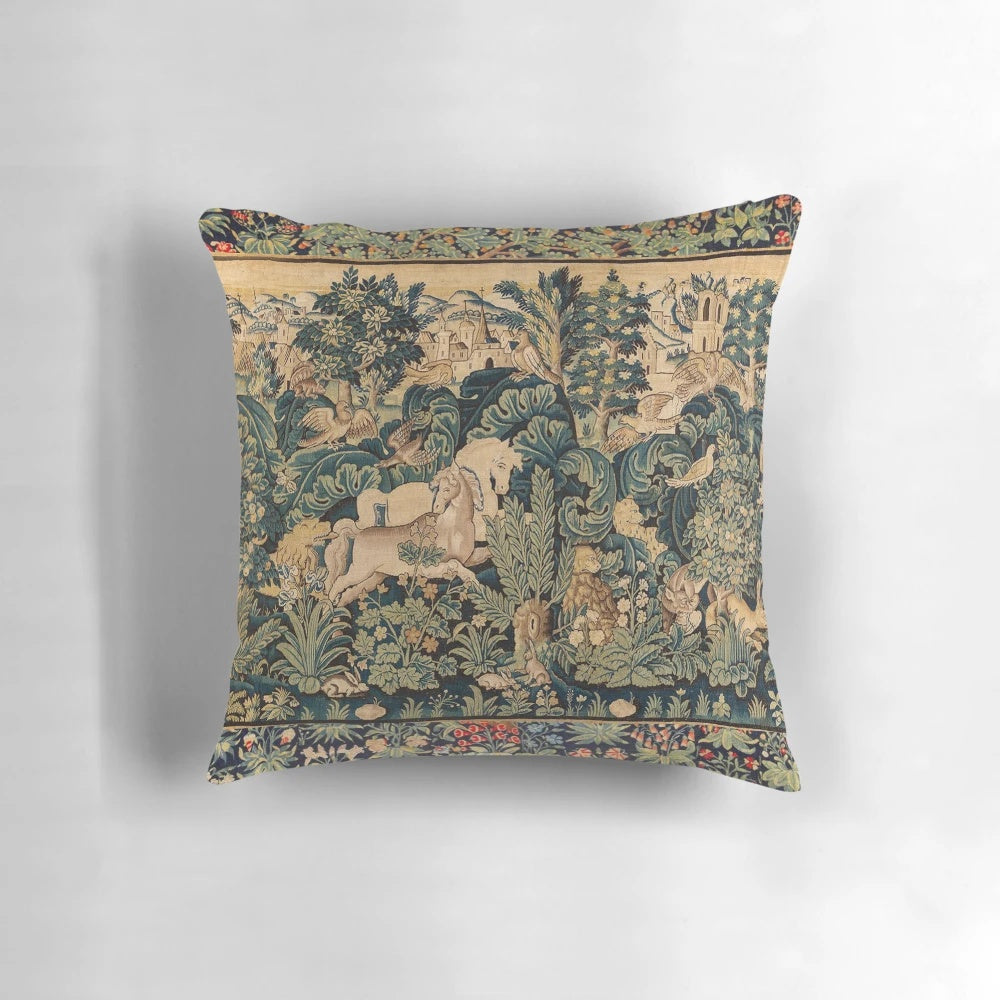 Decorative pillow featuring a tapestry-style design with fantasy animals and white horses in a woodland setting.