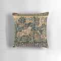Decorative pillow featuring a tapestry-style design with fantasy animals and white horses in a woodland setting.
