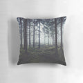 Pillow featuring a dreamy, misty forest scene with trees and fog