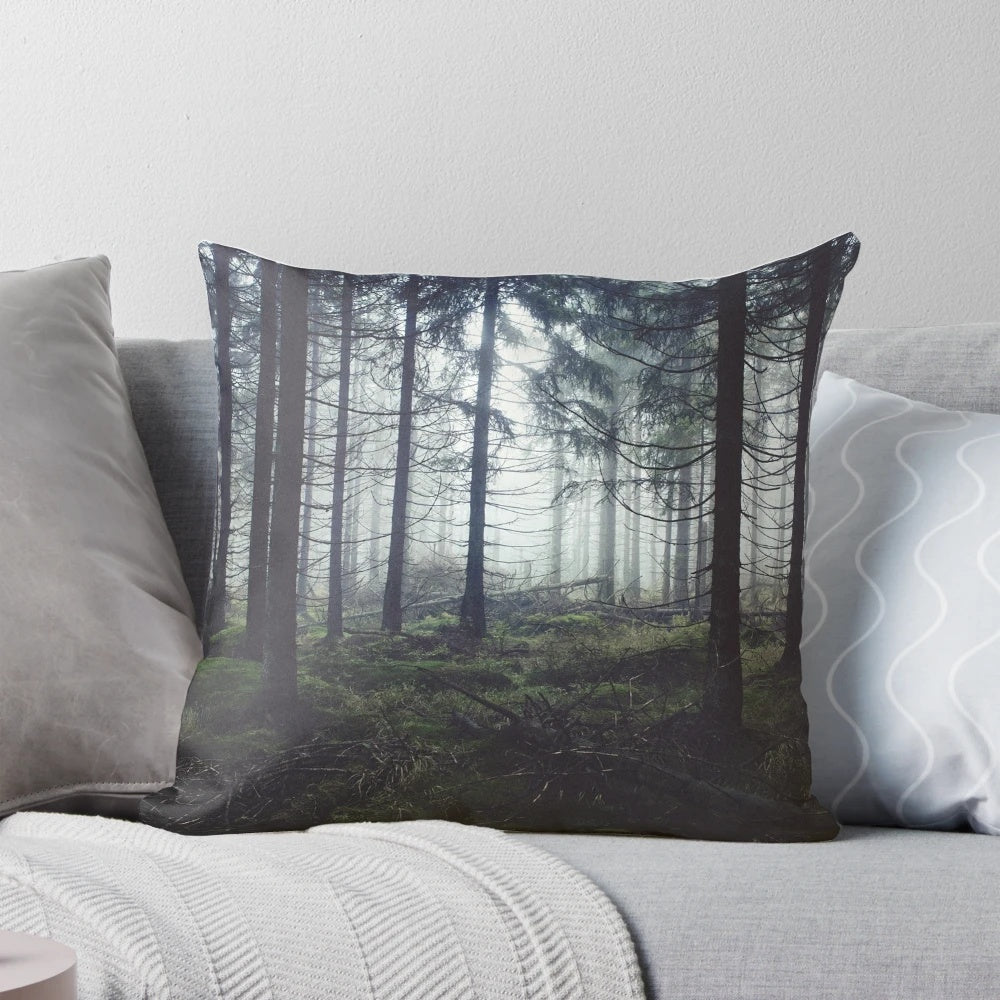 Pillow featuring a dreamy, misty forest scene with trees and fog