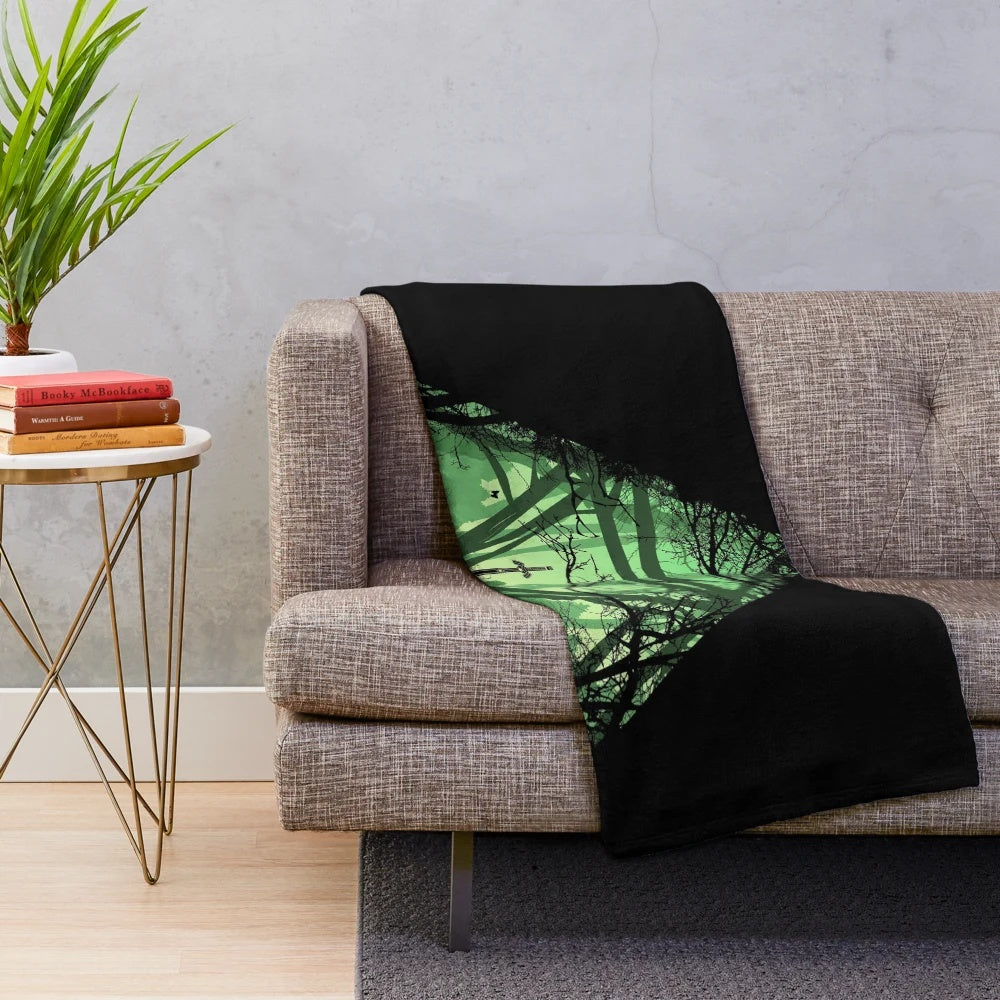 Plush blanket with fantasy landscape and sword design
