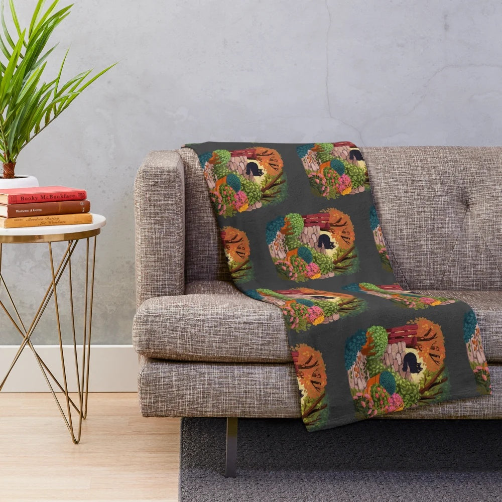 Cozy plush blanket featuring a playful cat in a magical garden setting