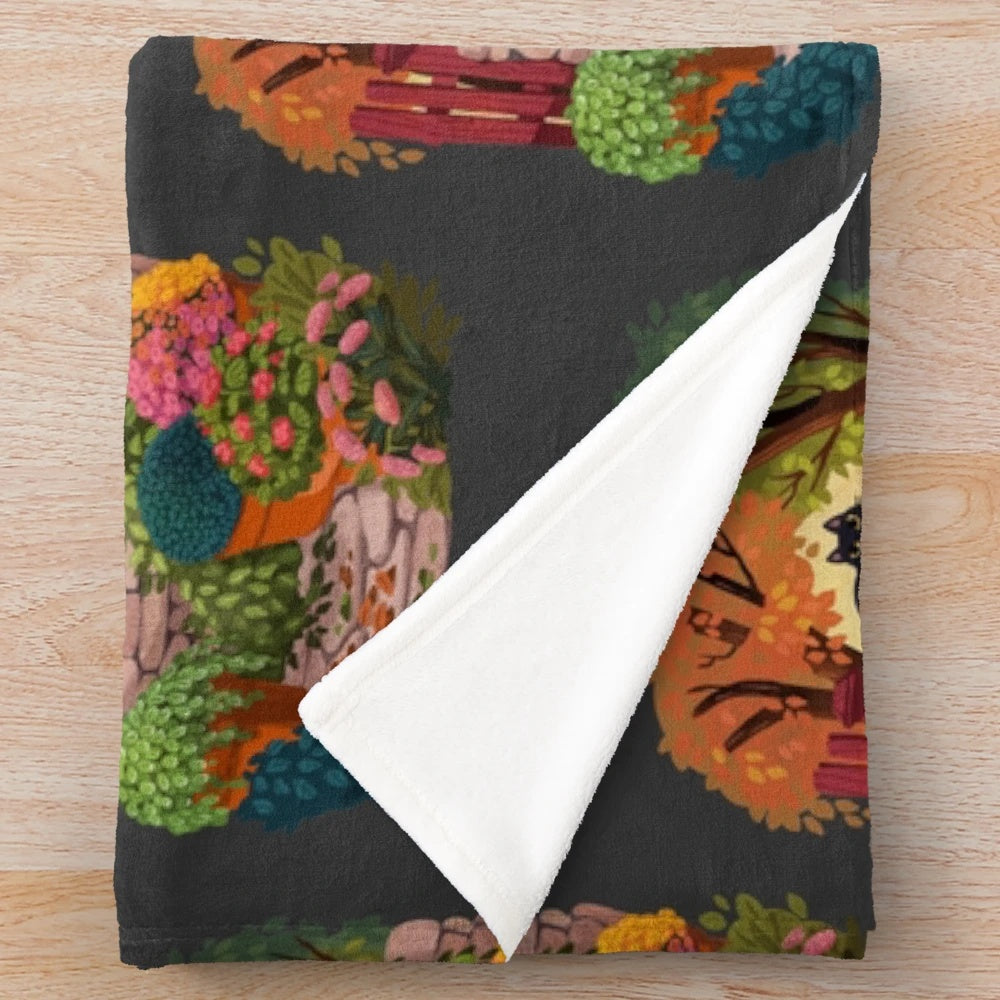 Cozy plush blanket featuring a playful cat in a magical garden setting