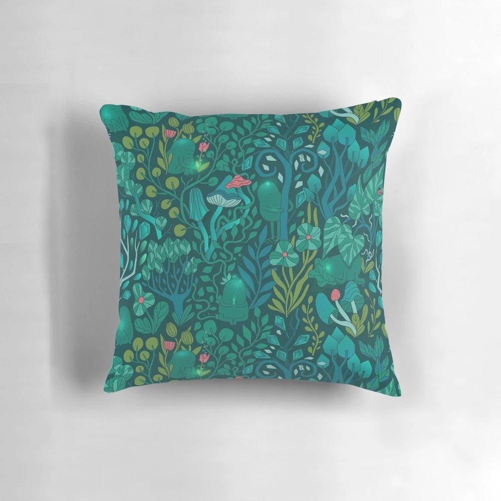 Decorative throw pillow featuring an illustration of emerald green forest animals, flowers, and mushrooms on a nature-inspired pattern.