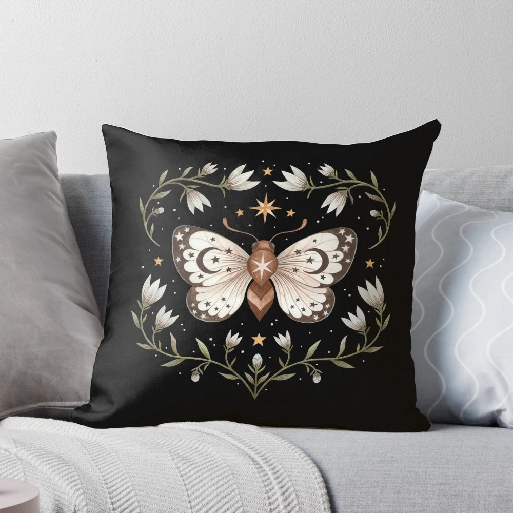 Mystical pillow with a design featuring moths, butterflies, and celestial elements