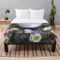 Plush blanket featuring a pen and ink illustration of a magical midnight garden scene with a glowing moon, flowers, and trees